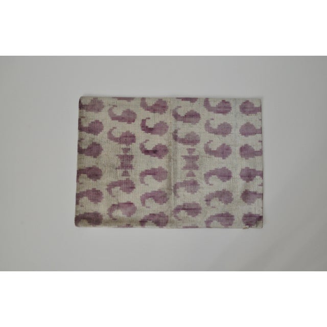 Whimsical Silk Velvet accent pillow with a patterned ikat fabric for the back. Pillow front features purple quote motifs....