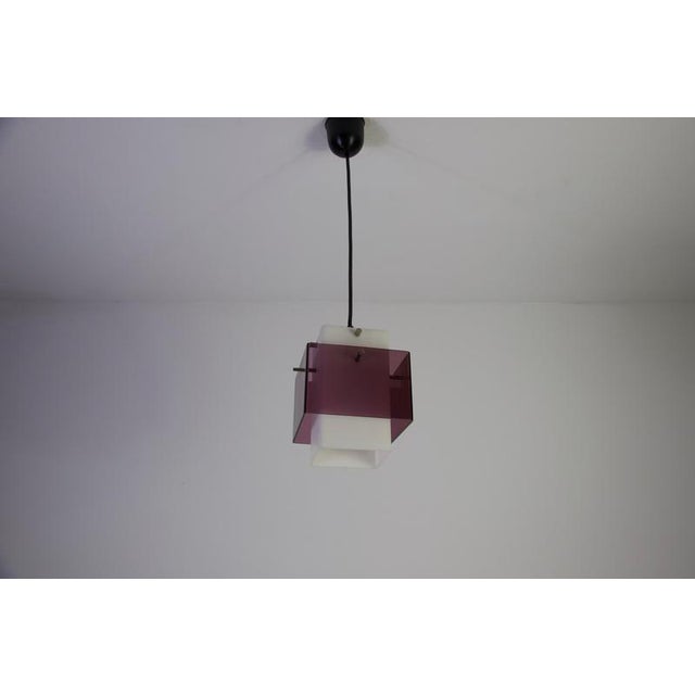 This acrylic glass pendant lamp was produced in germany in the 1970s and reflects the bold, geometric design language of...