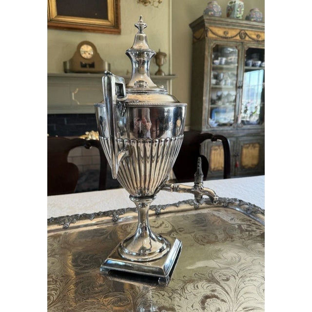 This antique silver-plate urn style dispenser some may call it a samovar is a beautiful addition to any collection. The...