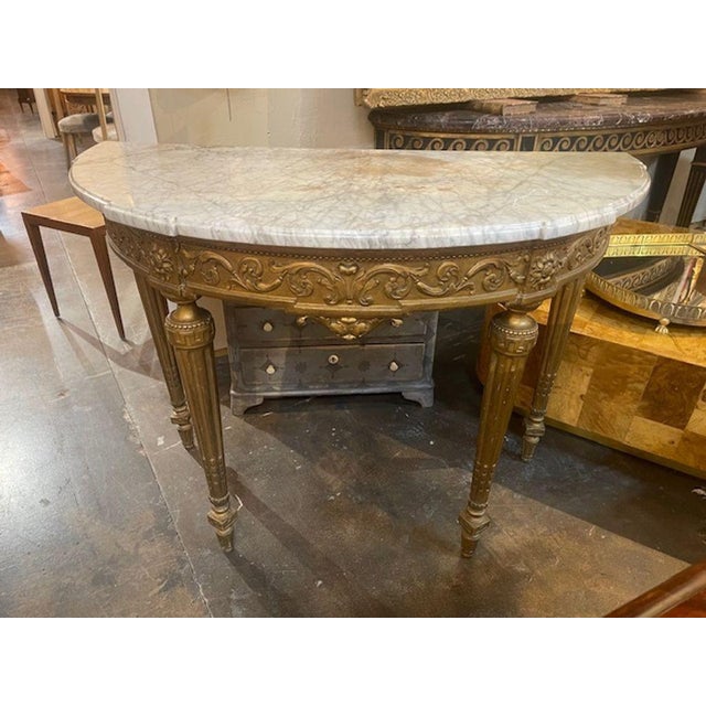 This 19th c. French Louis XVI Giltwood Console is a stunning piece of furniture with beautifully carved giltwood and a...