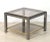 A handsome Italian square two-tiered low table or cocktail table of brass, chrome, and smoked glass by Zevi. Zevi was a...