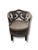Striking pair of upholstered accent chairs featuring dramatic scrollwork backs, curved silhouettes, and decorative...