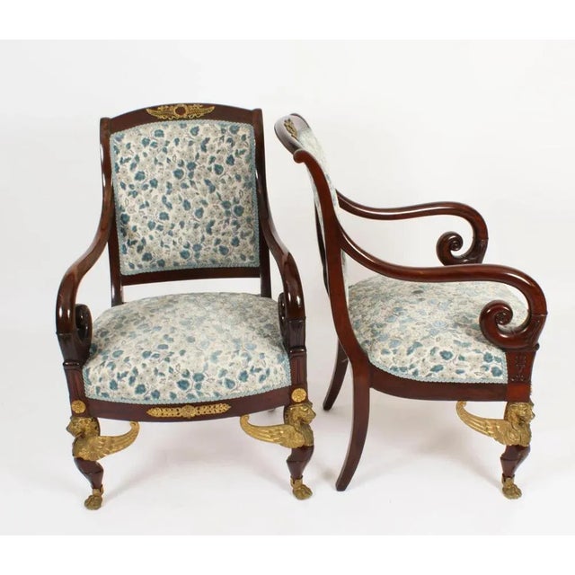 This is a fantastic and highly decorative antique pair of French ormolu mounted mahogany Empire fauteuil armchairs, circa...