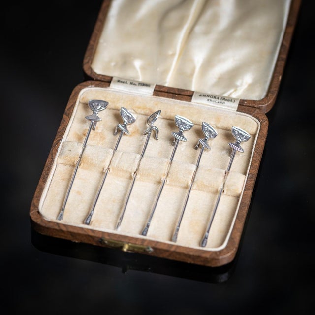 Vintage 20th century english solid silver set of six cocktail sticks, each ingeniously modelled as a champagne coupe,...