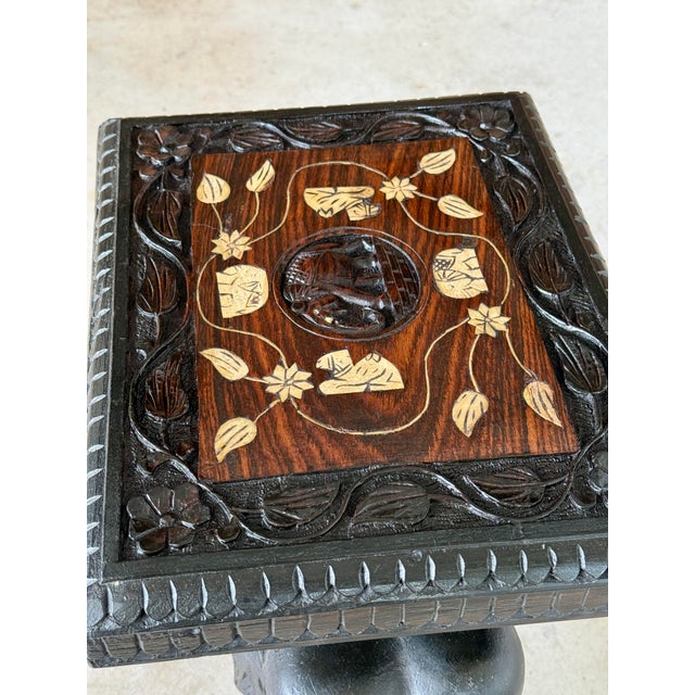 A charming mid-20th century hand-carved elephant side table, beautifully crafted from solid wood and topped with a...