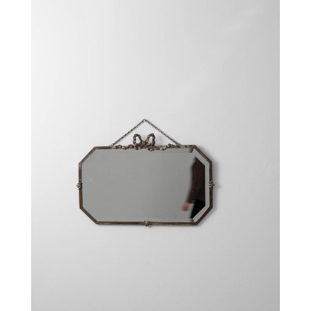 A circa 1930 French wall mirror designed with a suspended hanging chain, creating a simple yet distinctive mounting...