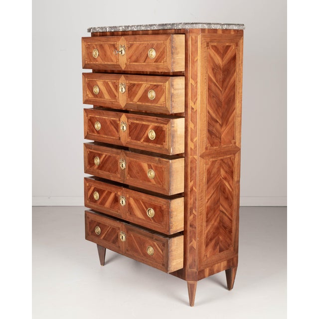 A fine early 19th century Louis XV style French marquetry chiffonier, or tall gentleman's chest. Expertly crafted with...