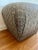 A vintage Marge Carson pouf, showcasing luxurious design and craftsmanship. This stylish pouf features premium upholstery...