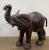 A fine large English model of an elephant from the early to mid-20th century, in cowhide leather with wooden tusks....
