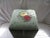 This is a Gorgeous Vintage Green Needlepoint Storage Footstool with a Green Velvet Bottom. the Piece has a Rose Design...