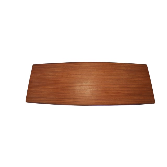 An elegant and well-proportioned Danish coffee table in teak and walnut with a design language that catches the eye from...