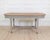Made in France around 1900, this shop cutting table is constructed in painted wood with a herringbone-patterned top....