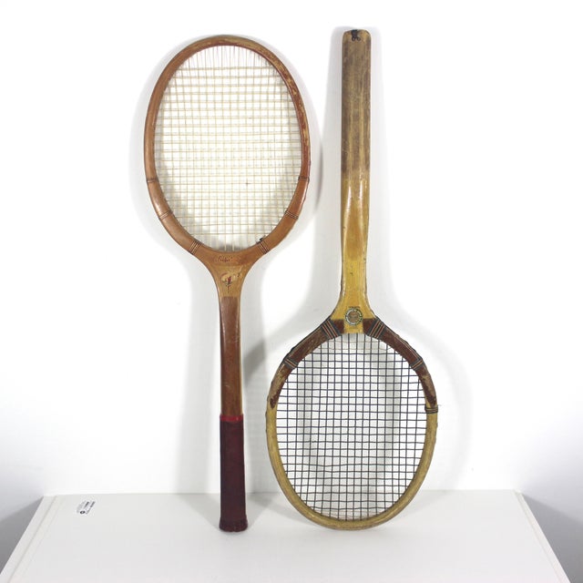 Width: 9 inches Height: 27 inches Depth: 1.5 inches Vintage curated set of two wooden tennis racquets for designer...