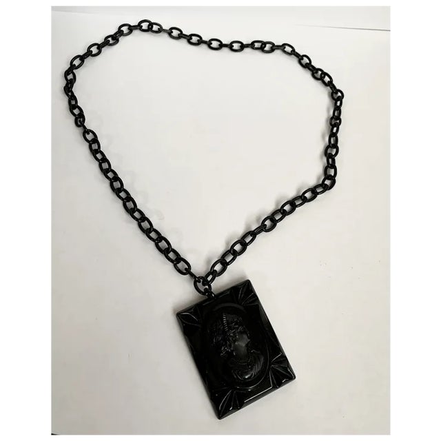 Stunning celluloid pendant and cameo. This is a very large cameo measuring 1 3/4" wide and 2 1/4" long. The entire pendant...