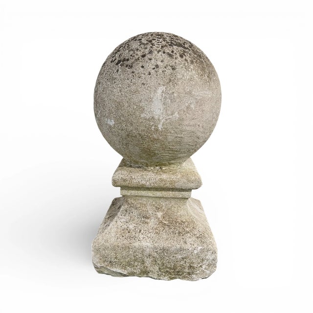 A compelling pair of 19th-century French stone ball finials that bring sculptural presence and timeless architectural...