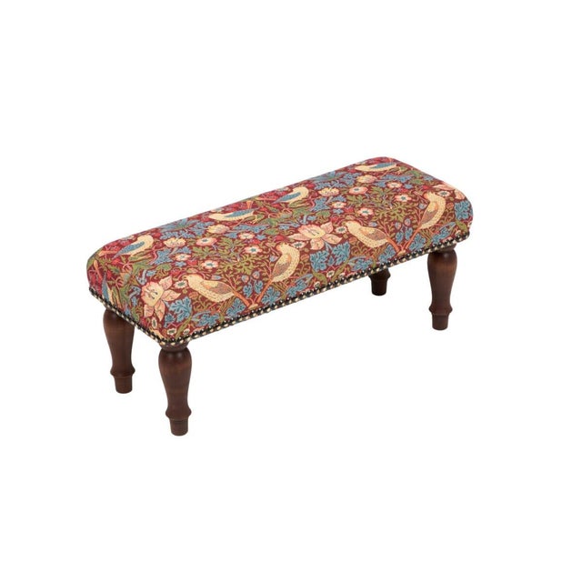 Meticulously handcrafted in the United Kingdom, this upholstered stool boasts classic studding and hand-polished solid...