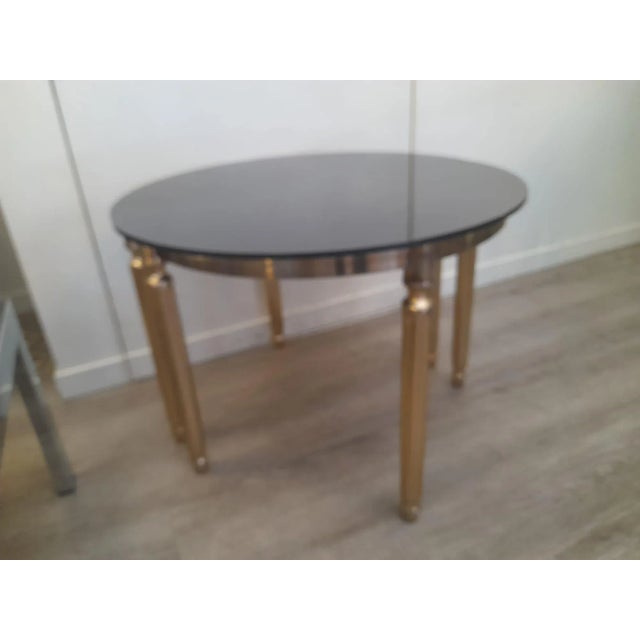 1970s Demi-lune golden metal smoked glasses small tables. These identical tables can be put together to form a rounded...