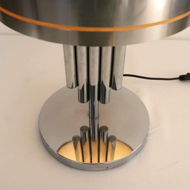 An iconic table lamp in true Space Age style, produced in the 1970s. This piece stands out for the strong geometric and...