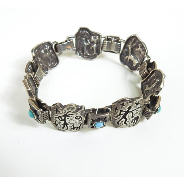 Late 20th century sterling silver and turquoise link bracelet. Marked sterling and with makers mark for Shube's...