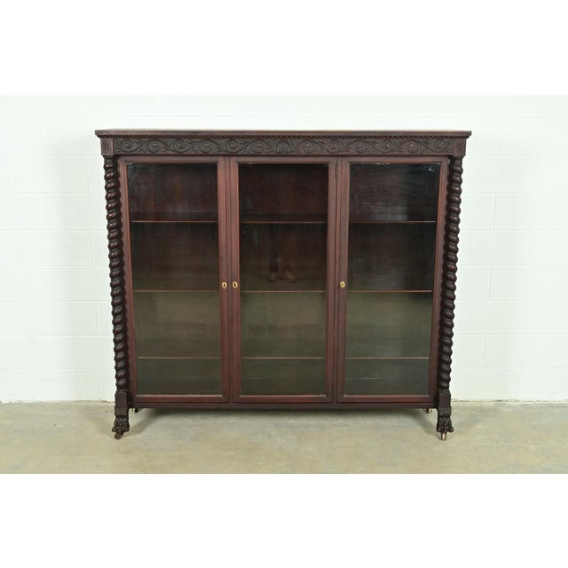 An outstanding antique American Empire or Victorian triple bookcase or display cabinet In the manner of R.J. Horner & Co....