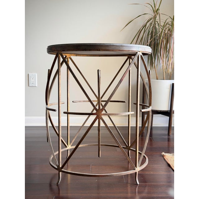 Vintage Hollywood Regency side table featuring an antiqued gold leaf wrought iron base with a sculptural geometric lattice...