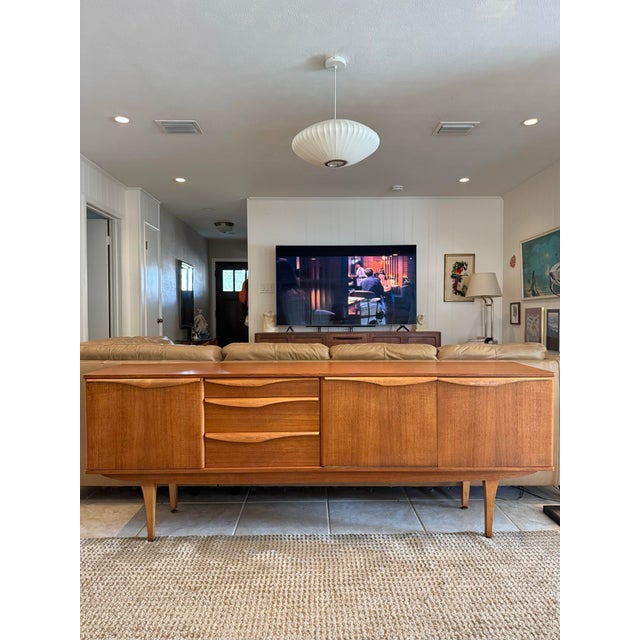 A beautiful teak sideboard by Stonehill Furniture, made in the UK, circa 1960s. It has gorgeous teak wood grain, sculpted...