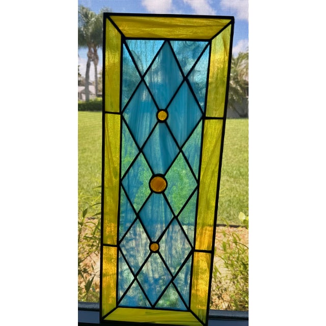 A striking vintage handcrafted leaded stained-glass architectural panel combining richly colored opalescent art glass with...