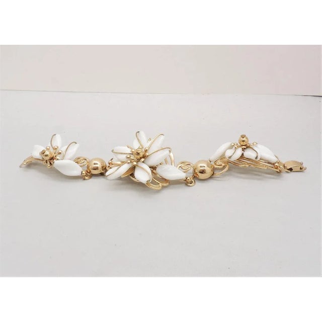 This is part of Chairish’s Costume Jewelry assortment. Rare 1950s goldtone white resin flowers with a full flower in the...
