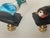 Cute pair of handmade small bird figurines mounted on brass bases as lamp finials.
