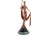 This solid bronze sculpture captures a dancer in an elegant pose, dressed in a long gown with fluid drapery. She lifts a...