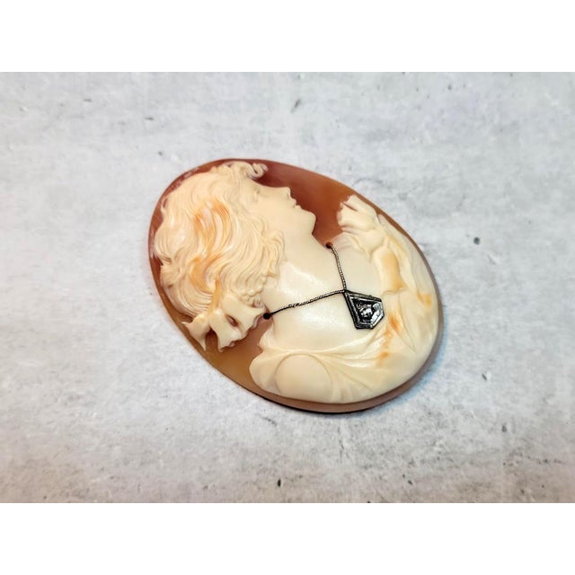 This vintage unmounted Carnelian shell cameo depicting the profile of the beautiful young lady is very well carved in...