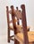 A striking pair of mid-century Mexican rustic wooden chairs, circa 1950–1970, distinguished by their unusual geometric...
