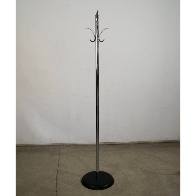 Vintage 1970's Mid century Modern coat rack for sale. It's made of chrome with a black metal base, and is in excellent...