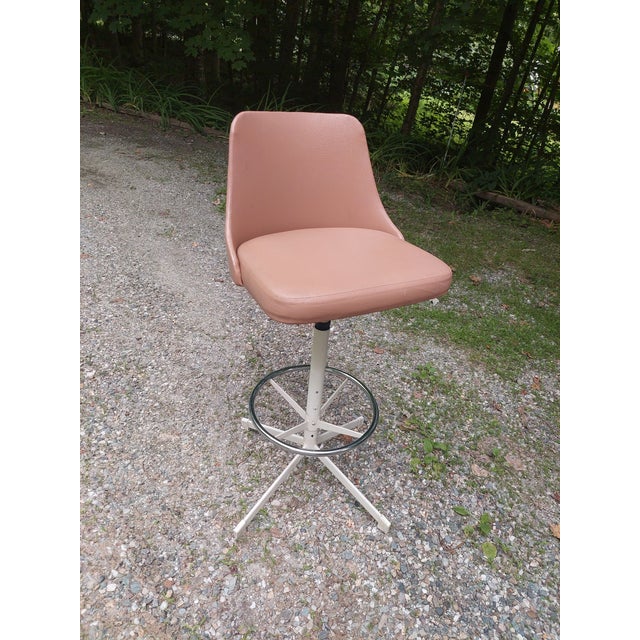 This vintage Hamilton Cosco swivel chair is a lovely dusty rose color, with 360° rotation and a vinyl seat. Made in the...