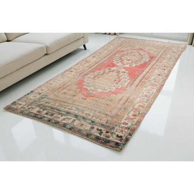 This is a vintage Turkish Oushak rug from the 1960s. The piece was hand-knotted.