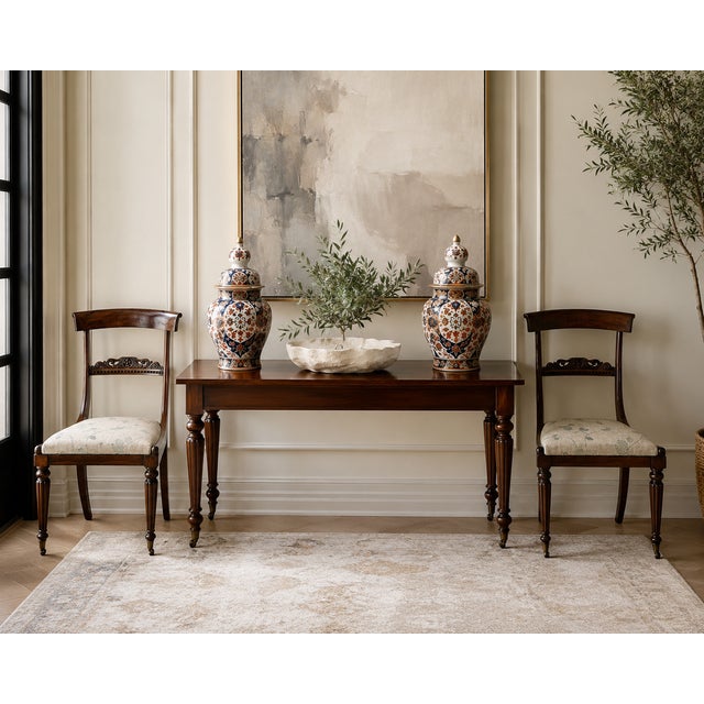 A fine pair of Regency rosewood side chairs dating to circa 1825. These elegant English chairs are well proportioned and...