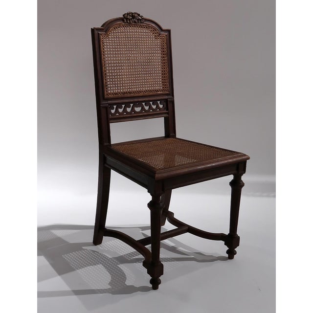 Constructed from solid wood, the frame features turned legs and a gently curved silhouette, complemented by a handwoven...