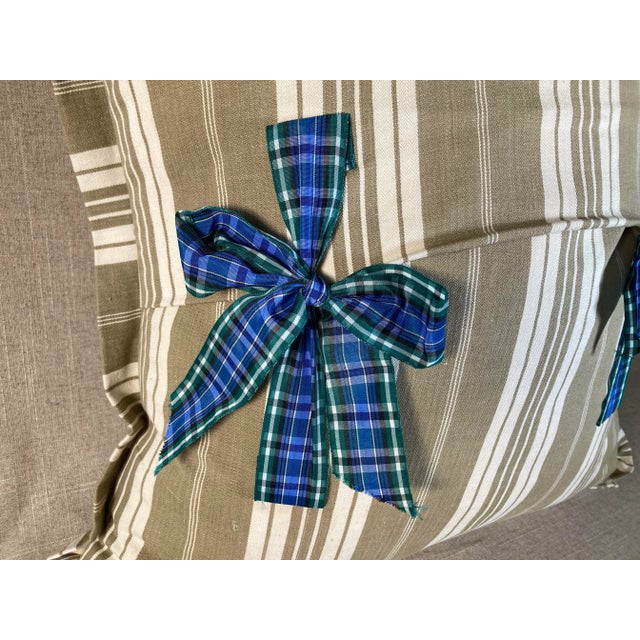 A pillow made from a circa 1960s printed linen, backed with antique ticking stripe cotton and tartan ties.