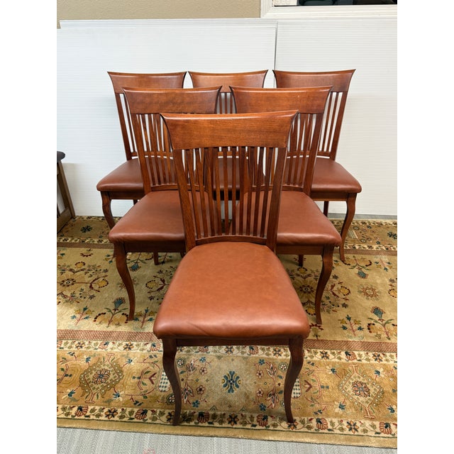 Design Plus Gallery presents a Set of Six Dining Chairs from Dinec. Built with solid wood frames in a medium brown stain,...