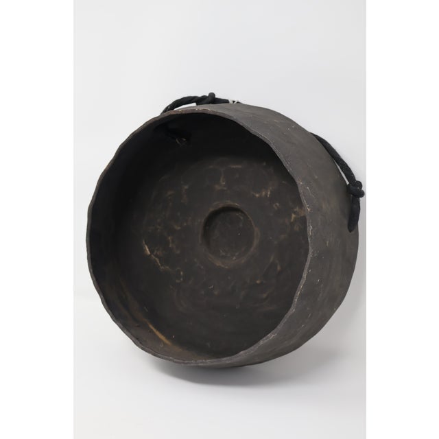 A distinctive Balinese bossed gong, identified by its accompanying old handwritten dealer tag as an antique instrument...