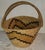 This hand woven basket with a handle is in fine condition and has a wonderful geometric pattern. circa 1940s