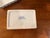 A small vintage Chinoiserie porcelain box with lid, hand-painted in classic blue and white with a soft pink lotus flower...