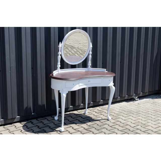 Antique dressing table from the early 20th century made in Provencal style. The furniture has three drawers under the top,...