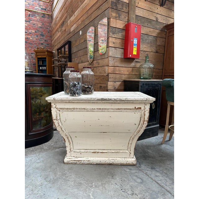 Antique curved counter dating from the early 20th century. It has a functional drawer at the back and two large storage...