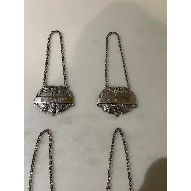 Beautiful set of 4 English sterling silver decanter labels by Turner & Simpson of England. The set consists of labels for...