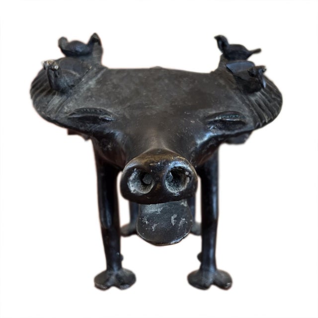 A fantastic bronze sculpture of a water buffalo, hosting her friendly ox-pecker birds. Benin style art and she is...