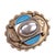 A polished oval silver boss set within a rope-twist border forms the raised centre of this multi-tiered brooch. Flanking...