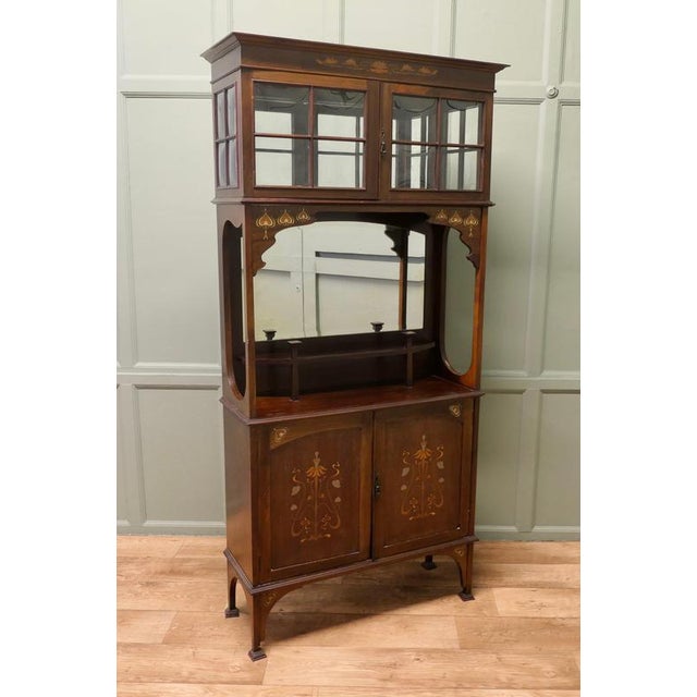 Art Nouveau Inlaid Display Cabinet, a Design by Shapland and Petter This piece is being offered from a dispersal sale of...