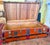 Brick red Antique trunk lined with cedar, straps across top and side, leather side handles, medallion style accents and...