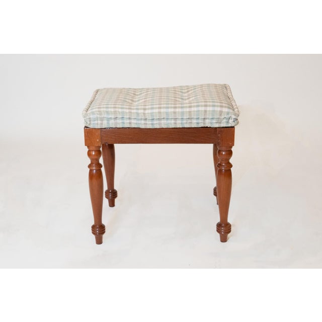 Each caned rectangular seat over a plain seat rail raised on turned legs; with loose tufted gingham squab seat cushions.